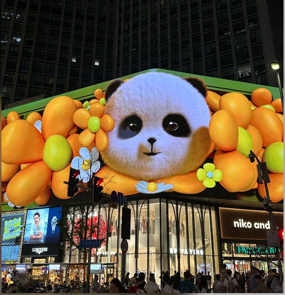 Large outdoor LED display on a shopping mall exterior wall